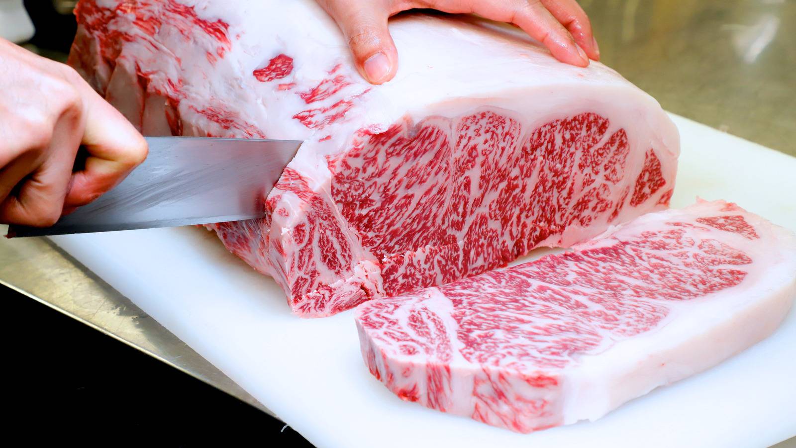 Kobe beef being cut with a sharp knife