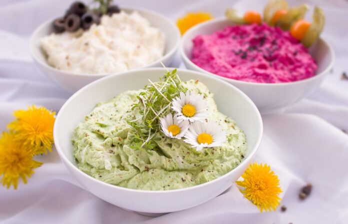Eco friendly spread packaging includes paper based tubs and compostable lids