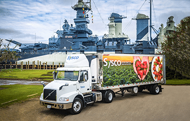 Sysco Foods Truck with branding leaving a factory